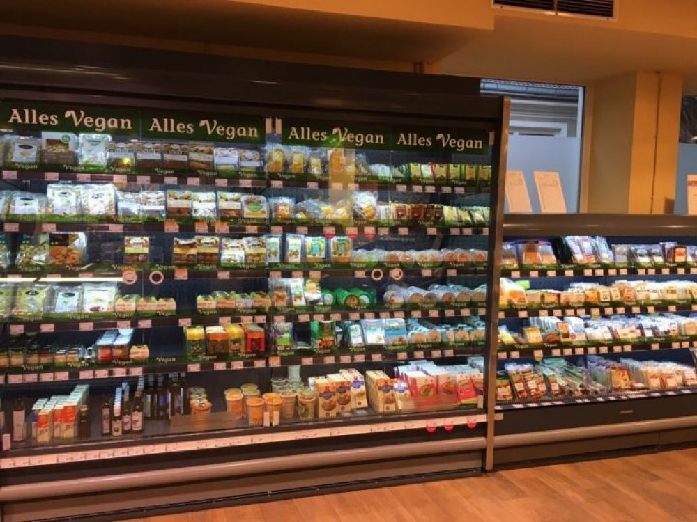 a fridge stocked with vegan food at Denn's Biomarket in Innsbruck