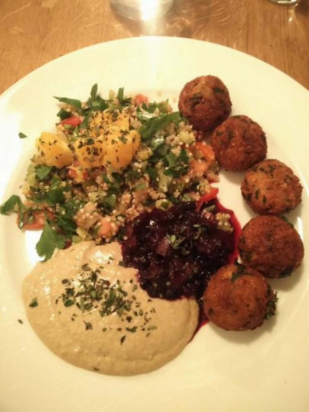 Olive restaurant's delicious vegan falafels with quinoa tabbouleh with orange and pomegranate, Maroccan salad, tahin creme and red wine grape chutney